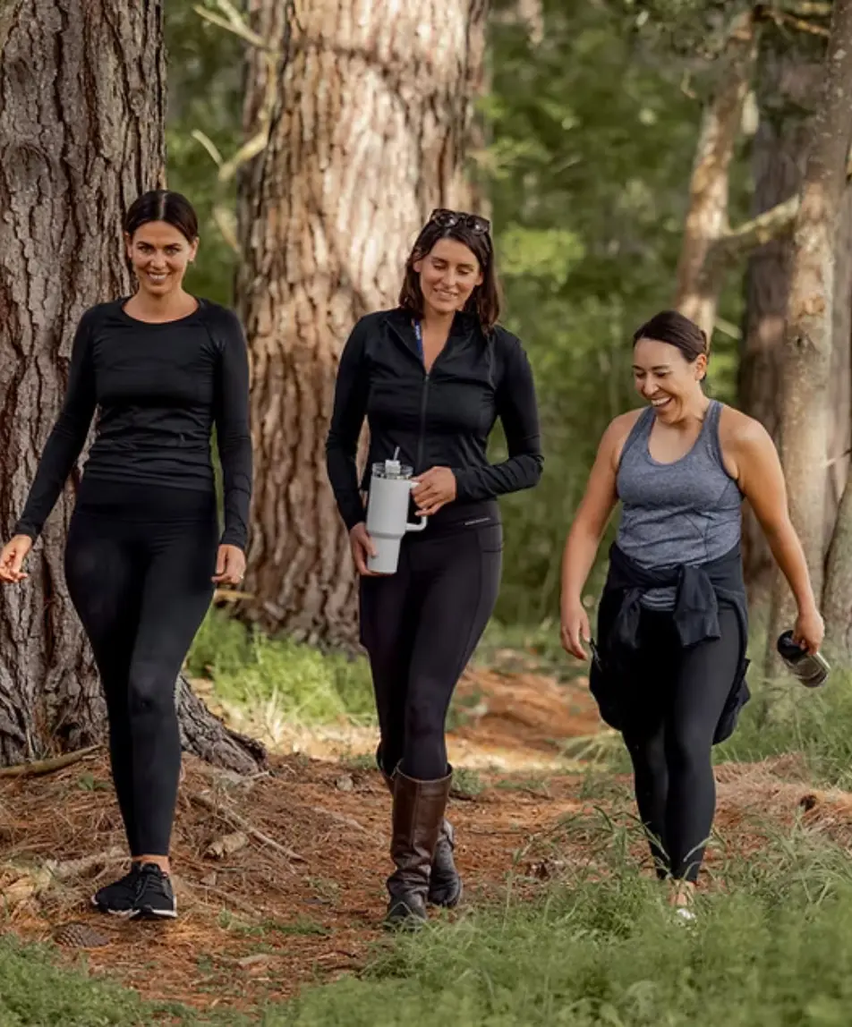 Guests walking together on a woodland trail