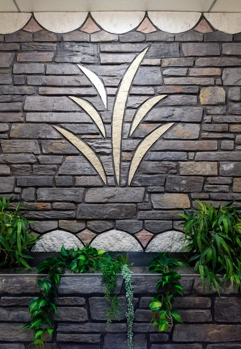 Decorative stone wall with the Karapiro Villas Resort emblem