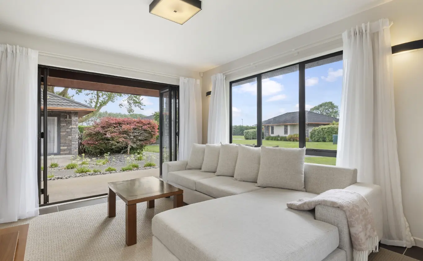 Garden villa lounge with wide windows and patio access